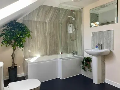 a bathroom with a sink and a shower and a toilet at Vennel Street Apartments in Stewarton