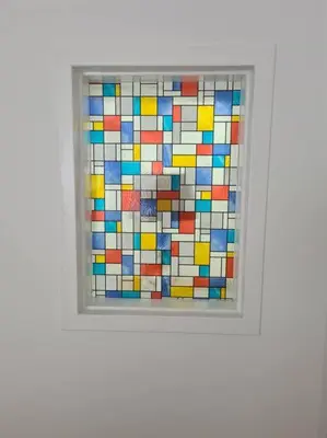 a window with a colorful mosaic tile on it at Lovely 2 Bedroom Garden Flat in trendy West End in Glasgow