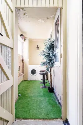 a hallway with green grass in a house at Lovely 1-bedroom property with balcony in West end in Glasgow