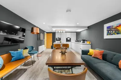 a living room with a couch and a table at RÌGH Properties - Luxury West End Artisan Apartment in Edinburgh