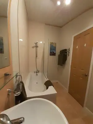 a bathroom with a bath tub and a sink at Sycamore Lodge Auchterarder in Auchterarder