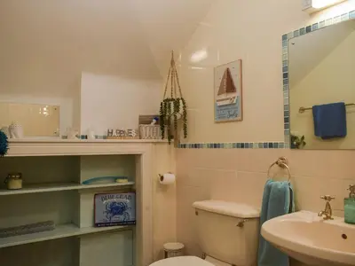 a bathroom with a toilet and a sink at The Old Post Office On Loch Tay in Stron-fearnan