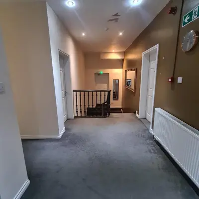 an empty hallway with a staircase in a house at The Beath Inn in Cowdenbeath