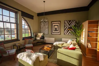 a living room with a couch and chairs and a tv at Glasgow Green Getaway with Free Parking in Glasgow