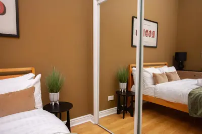 a mirror in a bedroom with two beds at Glasgow Green Getaway with Free Parking in Glasgow