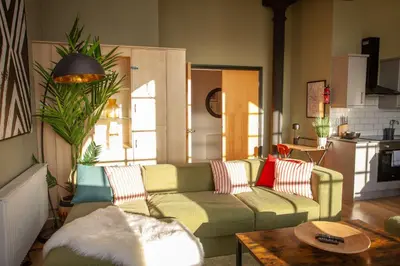 a living room with a couch and a table at Glasgow Green Getaway with Free Parking in Glasgow