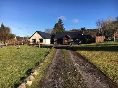 a dirt road in front of a house at Snowberry Cottage No 2 in Onich