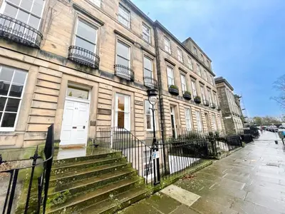 a building with a white door and stairs in front of it at 2Bed, Private Garden & Fireplace, Near Water of Leith in Edinburgh