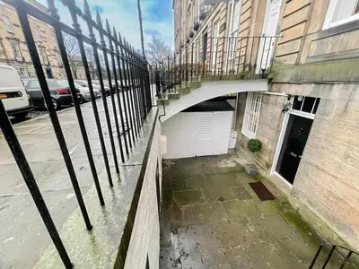 a bridge over a street next to a building at 2Bed, Private Garden & Fireplace, Near Water of Leith in Edinburgh