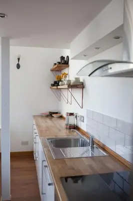a kitchen with a sink and a wooden counter top at Creathie Cathcart - Georgian Luxury at the beach in Ayr