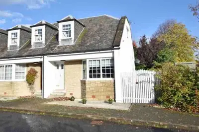 a white house with a white fence in front of it at Best location in town, it is all on the doorstep. in Ayr