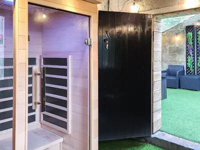 a black door in a room with a green lawn at Riverside Cottage in Larkhall