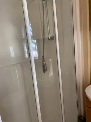 a shower with a glass door in a bathroom at Croft View in Taynuilt