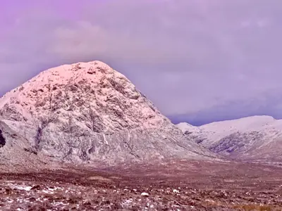 a snow covered mountain in the middle of a field at Corrie Apartment, Kinlochlaich House in Appin