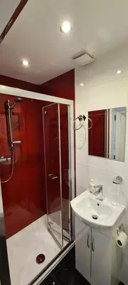 a bathroom with a shower and a sink at Lowefield B&B in Plean
