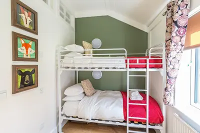a small room with bunk beds in a room at Squirrel Lodge 40 with Hot Tub in Newton Stewart