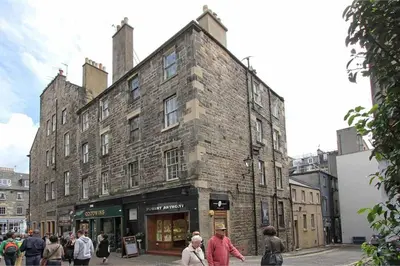 a large brick building with people walking in front of it at charm & character on historic Rose Street in Edinburgh