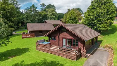an overhead view of a log cabin on a green lawn at Lady Galloway 30 with Hot Tub in Newton Stewart
