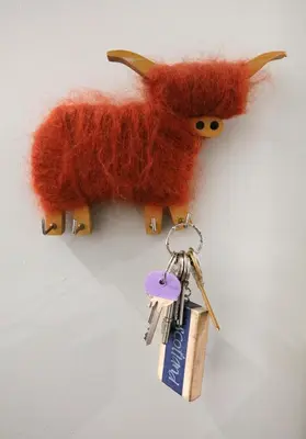 a bunch of keys and a stuffed animal hanging on a wall at The Botanics Residence in Edinburgh