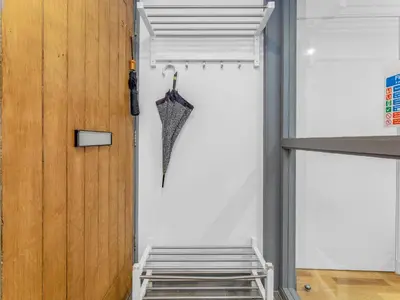 a room with a door and an umbrella on the wall at Cheerful Stays: 4 Bedroom Cottage in Arrochar in Arrochar