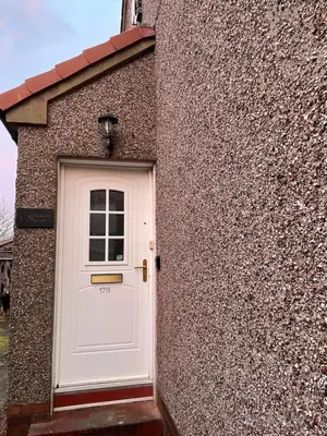 a white door on the side of a building at Windsor House in Falkirk