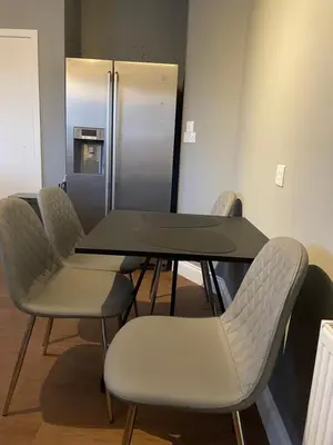 a conference room with a table and chairs and a refrigerator at Windsor House in Falkirk