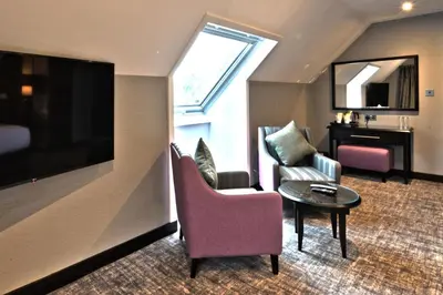 a living room with a couch and a table at The Beach House Loch Lomond in Luss