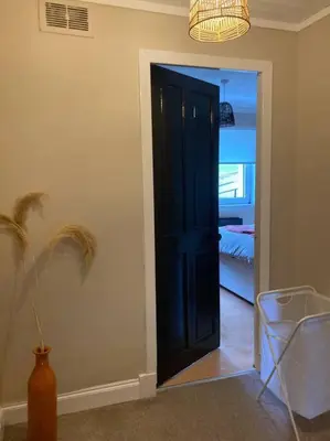 a room with a door leading to a bedroom at Budget friendly apartment with stairs Near Glasgow airport and Loch Lomond in Clydebank