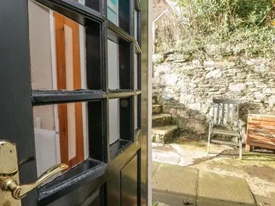an open door with a view of a yard at The Coach House in Oban