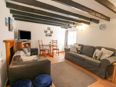 a living room with a couch and a table at The Coach House in Oban