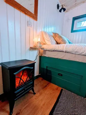 a bedroom with a fireplace next to a bed at The Best Moments Start Here in Corrie