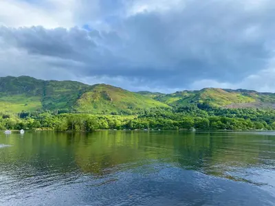 a view of a lake with mountains in the background at Rowan in Crieff