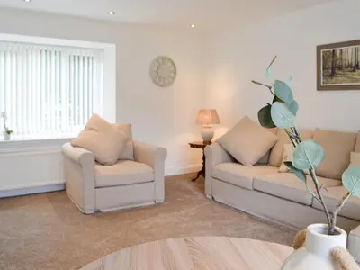 a living room with two couches and a table at Kirroughtree Steading 2 - Uk42904 in Newton Stewart