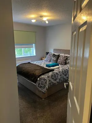 a bedroom with a bed and a window at 5 minutes to Glasgow airport in Paisley