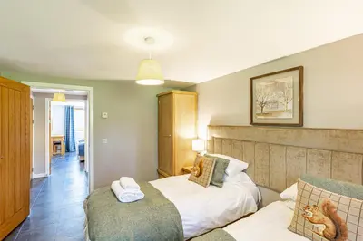 a bedroom with a bed and a couch at Lord Galloway 31 with Hot Tub in Newton Stewart