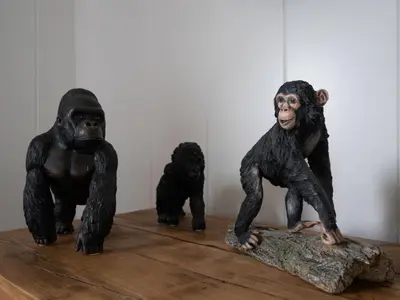 three statues of chimpanzees sitting on a table at Chalet Loch Leven Lodge 25 East by Interhome in Kinross