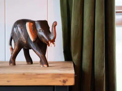 a wooden elephant statue sitting on top of a table at Chalet Loch Leven Lodge 25 East by Interhome in Kinross