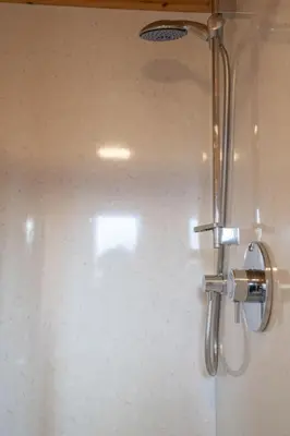 a shower with a chrome shower head in a bathroom at Chalet Loch Leven Lodge 10 by Interhome in Kinross