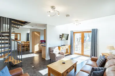 a living room with a couch and a table at Lord Galloway 34 with Hot Tub in Newton Stewart