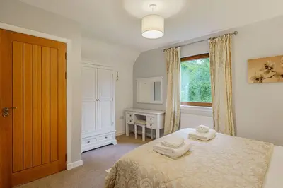a bedroom with a bed with two towels on it at Lord Galloway 35 with Hot Tub in Newton Stewart