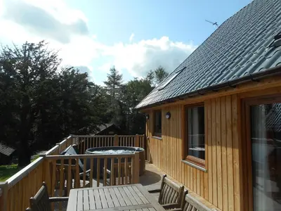 a wooden deck with a hot tub on a house at Lord Galloway 36 with Hot Tub in Newton Stewart