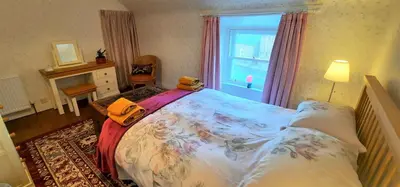 a bedroom with a large bed and a window at Greenbrae East in Crieff