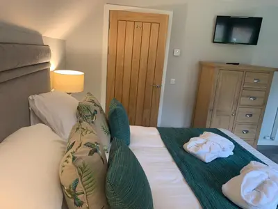 a bedroom with a bed with towels on it at Lord Galloway 37 with Hot Tub in Newton Stewart