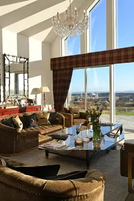 a living room with couches and a table and chairs at Kipney Farmhouse with hot tub in Perth