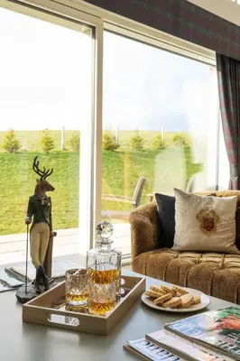 a living room with a table with a deer statue on it at Lapwing - Stylish one bedroom country steading in Perth