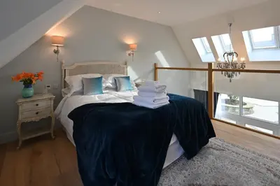 a bedroom with a bed with towels on it at Oystercatcher - Converted luxury steading in Perth