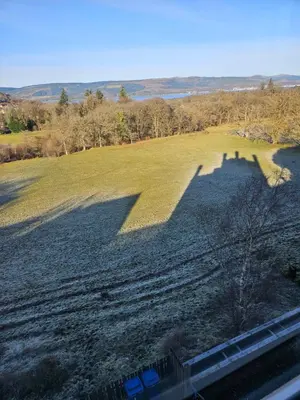a shadow of a group of people on a field at Langhouse Castle Bed and Breakfast in Inverkip