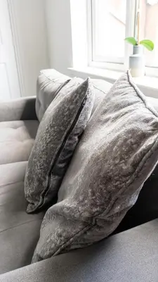 two pillows on a couch in a living room at Ferguson House in Airdrie