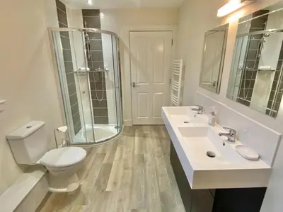 a bathroom with a toilet and a sink and a shower at Brodie Cottage in Killin