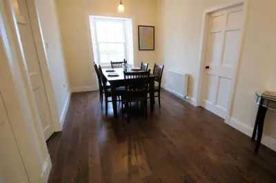 a dining room with a table and chairs at Comrie Old Schoolhouse in Comrie